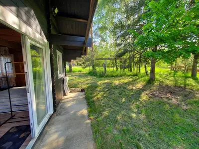 a porch of a house with a window and a yard at Le Chalet du Grain d'Orient in Caudiès-de-Fenouillèdes