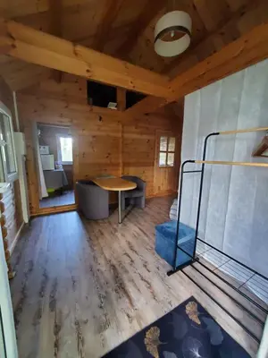 a room with a table and a bed in a cabin at Le Chalet du Grain d'Orient in Caudiès-de-Fenouillèdes