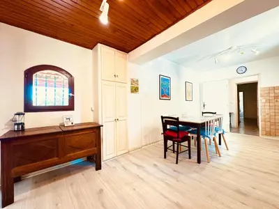 a dining room with a wooden table and chairs at Maison entière tout confort pour 7 personnes in Bize-Minervois
