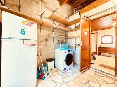 a kitchen with a refrigerator and a washing machine at Maison entière tout confort pour 7 personnes in Bize-Minervois