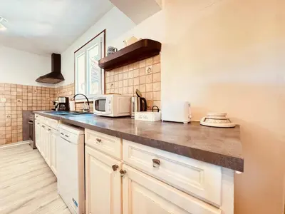 a kitchen with a counter top with two microwaves at Maison entière tout confort pour 7 personnes in Bize-Minervois