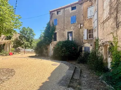 an empty street in front of a building at La Maison du Rond in Coustouge