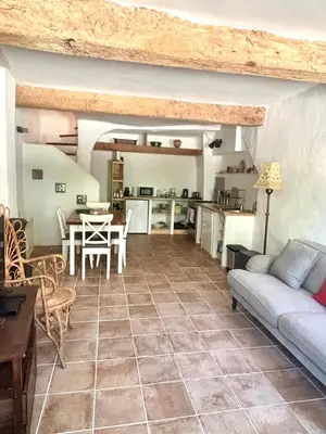 a living room with a couch and a table at La Maison du Rond in Coustouge