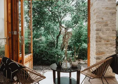 a patio with a table and two chairs and a window at Gîte - Holiday Home Vent Cers in Limoux