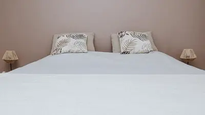 a bedroom with a white bed with two pillows at Gîte - Holiday Home Vent Cers in Limoux