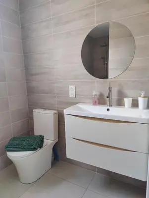 a bathroom with a sink and a toilet and a mirror at Studio cosy proche des vignes in Roubia