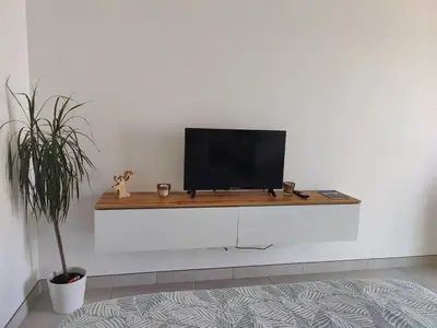 a tv sitting on top of a white wall at Studio cosy proche des vignes in Roubia
