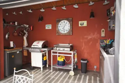 a kitchen with a stove and a clock on the wall at Havre de paix avec piscine et jacuzzi Narbonne in Ventenac en Minervois