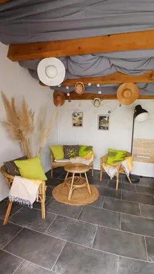 a living room with chairs and a table at Havre de paix avec piscine et jacuzzi Narbonne in Ventenac en Minervois
