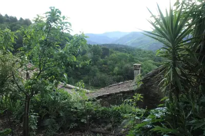 two chairs sitting on the grass near a mountain at Maison de la Mûre, Haut-Languedoc Park in Saint-Vincent