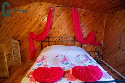 two hearts on a bed in a room at Séjour détente avec spa, piscine et sauna in Mas-Saintes-Puelles