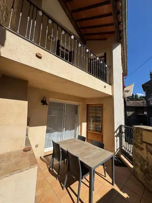 a table and chairs on the patio of a house at L'Estaple in Berlou