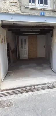 an empty garage with two doors in a building at Chez Timmy in Oupia