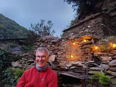 a man standing in front of a stone building at Chambre et b&b in Miraval-Cabardès