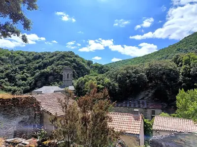 a view of a village with mountains in the background at Chambre et b&b in Miraval-Cabardès