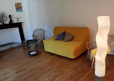 a living room with a couch and a fireplace at Chambre b&b in Miraval-Cabardès