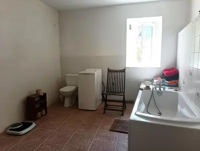 a bathroom with a tub and a toilet and a sink at Chambre b&b in Miraval-Cabardès