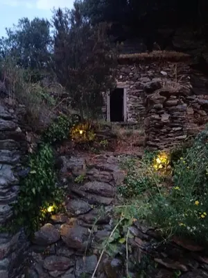 an old stone house with lights in the yard at Chambre b&b in Miraval-Cabardès