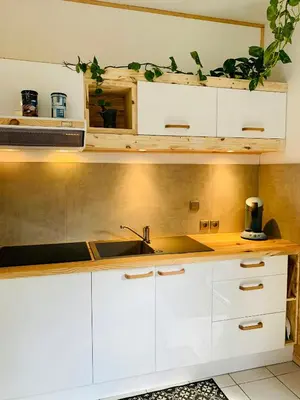 a kitchen with white cabinets and a sink at Peaceful Gite By The Black Mountain in Caunes-Minervois
