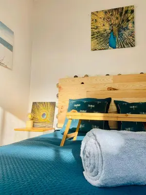 a room with a bed and a table and pillows at Peaceful Gite By The Black Mountain in Caunes-Minervois