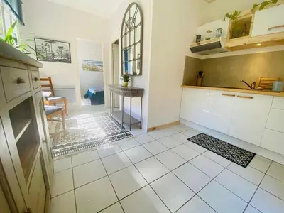 a kitchen with white cabinets and a tile floor at Peaceful Gite By The Black Mountain in Caunes-Minervois