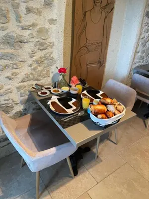 a table with a tray of breakfast foods on it at Chambre d'Hôtes - B&B La Moneze Basse in Limoux