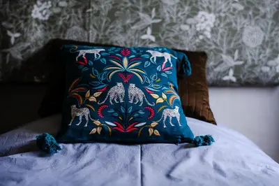 a blue pillow sitting on top of a bed at Chambre d'Hôtes - B&B La Moneze Basse in Limoux