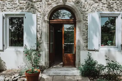 an entrance to a stone building with a wooden door at Chambre d'Hôtes - B&B La Moneze Basse in Limoux