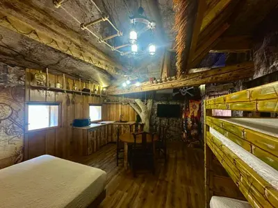 a bedroom with a bed and a table in it at Studio repaire des pirates du Cloitre in Narbonne
