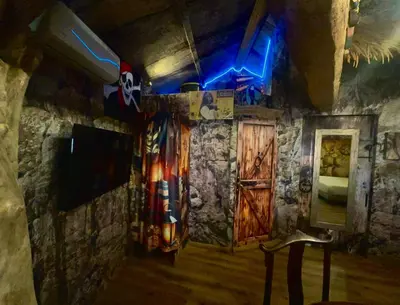 a room with a stone wall and a door at Studio repaire des pirates du Cloitre in Narbonne