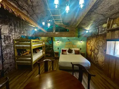 a room with two bunk beds and a table and chairs at Studio repaire des pirates du Cloitre in Narbonne