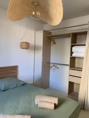 a bedroom with a bed and a closet with towels at Gili Air, Les Halles et les Grands Buffets in Narbonne