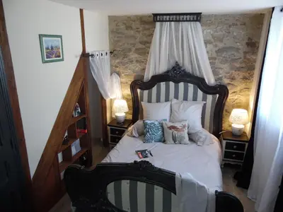 a bedroom with a bed with a canopy at Chez Jérôme, au pied de la cité médiévale in Carcassonne