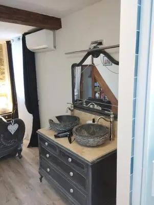 two sinks on top of a dresser with a mirror at Chez Jérôme, au pied de la cité médiévale in Carcassonne