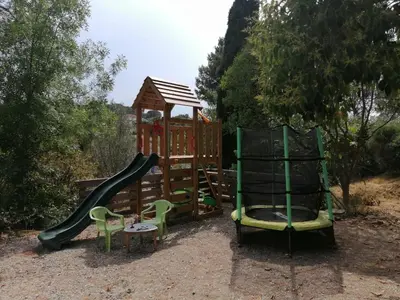 a playground with a slide and a play structure at Maison dans les Corbières in Montséret