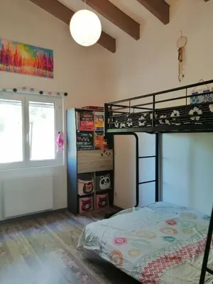 a bedroom with a bunk bed and a window at Maison dans les Corbières in Montséret