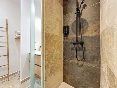 a bathroom with a shower with a glass door at Cottages Occitans in Villepinte
