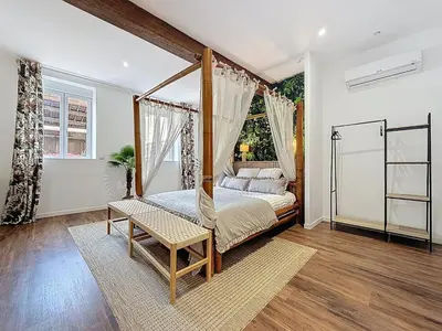 a bed with a canopy in a room at Cottages Occitans in Villepinte