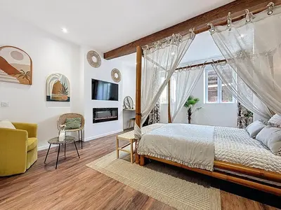 a bedroom with a bed with a canopy at Cottages Occitans in Villepinte