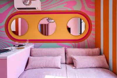 a bedroom with a bed with a mirror above it at La Villa Orange - DISCO - proche cité médiévale et centre ville à pied in Carcassonne