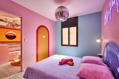 a bedroom with a bed with a teddy bear on it at La Villa Orange - DISCO - proche cité médiévale et centre ville à pied in Carcassonne