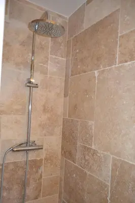 a shower with a metal shower head in a bathroom at Villa MAGRI 3 bedrooms in Cuxac-dʼAude