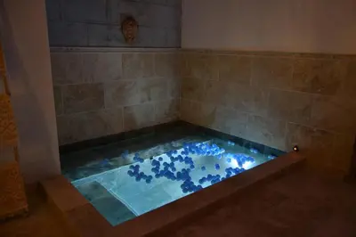 a bath tub with blue stones in a shower at Villa MAGRI 3 bedrooms in Cuxac-dʼAude