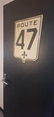 a black door with a route sign on it at Relais Motards de Portel in Portel-des-Corbières