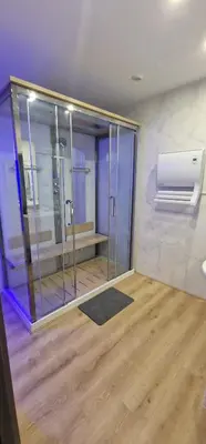 a bathroom with a glass shower in a room at Relais Motards de Portel in Portel-des-Corbières