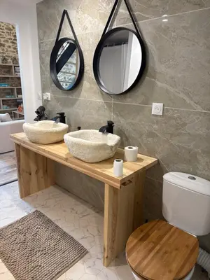 a bathroom with two sinks and two mirrors at Domaine Rams in Villegailhenc