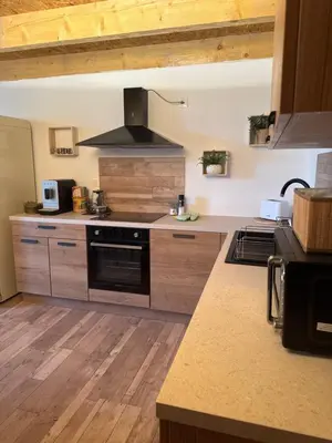 a kitchen with wooden counters and a stove top oven at Domaine Rams in Villegailhenc