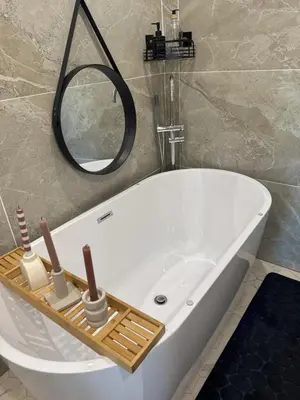 a bathroom with a bath tub with a mirror at Domaine Rams in Villegailhenc