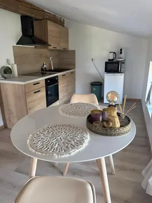 a white table and chairs in a kitchen at Domaine Rams in Villegailhenc