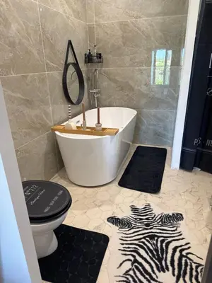 a bathroom with a tub and a toilet and a sink at Domaine Rams in Villegailhenc